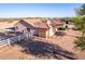 The home has a large backyard area with a fenced perimeter, desert landscaping and a brick pathway at 23717 N Mustang Way, Florence, AZ 85132