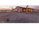 Expansive backyard with gravel, mature trees, and a covered patio at 23717 N Mustang Way, Florence, AZ 85132