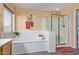 Bright bathroom featuring a soaking tub, a glass-enclosed shower, and decorative accents at 23717 N Mustang Way, Florence, AZ 85132