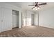 Bedroom with a ceiling fan, closet, and neutral decor creates a calming atmosphere at 23717 N Mustang Way, Florence, AZ 85132