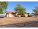 Single-level home featuring mature trees, brick border, and well-kept lawn for curb appeal at 23717 N Mustang Way, Florence, AZ 85132