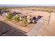 Aerial view featuring a large lot with solar panels, desert landscaping, and white fencing at 23717 N Mustang Way, Florence, AZ 85132