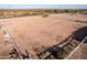 Aerial view highlighting the property's vast desert surroundings, white fencing, and privacy at 23717 N Mustang Way, Florence, AZ 85132