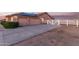Large driveway leads to the home, complete with a two-car garage and white perimeter fencing at 23717 N Mustang Way, Florence, AZ 85132