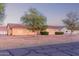 Single-story residence with mature trees, a decorative brick border, and a well-maintained lawn at 23717 N Mustang Way, Florence, AZ 85132