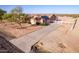 A high-angle shot highlighting the home's curb appeal and landscaping at 23717 N Mustang Way, Florence, AZ 85132