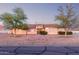 Charming single-story home with brick-lined walkway and mature trees enhancing its curb appeal at 23717 N Mustang Way, Florence, AZ 85132