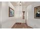 Inviting foyer with neutral tile flooring and elegant artwork on the white walls at 23717 N Mustang Way, Florence, AZ 85132