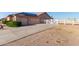 Two-car garage with concrete driveway, desert landscaping and white fencing at 23717 N Mustang Way, Florence, AZ 85132