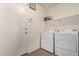 Functional laundry room with washer, dryer, and convenient storage shelves at 23717 N Mustang Way, Florence, AZ 85132