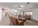 Bright, open living room features ample seating, tile flooring and access to dining area at 23717 N Mustang Way, Florence, AZ 85132
