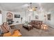Living room featuring a fireplace, ceiling fan and comfortable seating, with neutral walls at 23717 N Mustang Way, Florence, AZ 85132