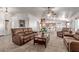 Inviting living room featuring neutral walls, a ceiling fan and comfortable brown couches at 23717 N Mustang Way, Florence, AZ 85132