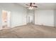Spacious main bedroom featuring carpet, a ceiling fan, and an ensuite bathroom for added convenience at 23717 N Mustang Way, Florence, AZ 85132