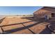 An exterior shot showcases the property's expansive sideyard enclosed with white fencing at 23717 N Mustang Way, Florence, AZ 85132