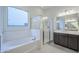 Elegant bathroom with a soaking tub, glass shower, and modern fixtures at 242 S 165Th Ave, Goodyear, AZ 85338