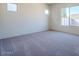Bright bedroom featuring plush carpeting, neutral walls, and natural light from windows at 242 S 165Th Ave, Goodyear, AZ 85338