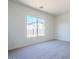 Comfortable bedroom with carpeted floors, neutral walls, and a large window at 242 S 165Th Ave, Goodyear, AZ 85338