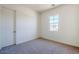 Cozy bedroom with carpeted flooring, a window, and a white door at 242 S 165Th Ave, Goodyear, AZ 85338