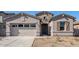 Charming single-story home with stucco siding, stone accents, and a two-car garage at 242 S 165Th Ave, Goodyear, AZ 85338