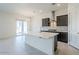 Modern kitchen with large island, stainless steel appliances, and stone countertops at 242 S 165Th Ave, Goodyear, AZ 85338