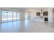 Open-concept living and kitchen area with sliding glass doors and tile flooring at 242 S 165Th Ave, Goodyear, AZ 85338