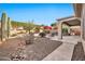 Serene backyard with desert landscaping, covered patio, and a tranquil ambiance for outdoor enjoyment at 2462 W Turtle Hill Dr, Anthem, AZ 85086