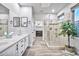 Bright bathroom featuring double sinks, modern mirrors, and walk-in shower at 2462 W Turtle Hill Dr, Anthem, AZ 85086