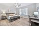 Cozy bedroom with wood-look floors, a ceiling fan, and a relaxing color scheme, providing a comfortable retreat at 2462 W Turtle Hill Dr, Anthem, AZ 85086