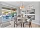 Bright dining room with wood floors, contemporary furniture, and patio views at 2462 W Turtle Hill Dr, Anthem, AZ 85086