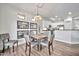 Bright dining room with wood floors, contemporary furniture, and kitchen views at 2462 W Turtle Hill Dr, Anthem, AZ 85086