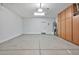 Spacious garage with ample storage cabinets and clean flooring, providing functionality and organization at 2462 W Turtle Hill Dr, Anthem, AZ 85086