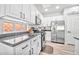 Updated kitchen featuring white cabinets, stainless steel appliances, and granite countertops, providing a modern, functional space at 2462 W Turtle Hill Dr, Anthem, AZ 85086