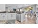 Modern kitchen with granite countertops, white cabinetry, stainless steel dishwasher, and adjacent dining area at 2462 W Turtle Hill Dr, Anthem, AZ 85086