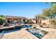 Backyard oasis featuring a sparkling pool, spa, and outdoor seating area for relaxation and entertainment at 2462 W Turtle Hill Dr, Anthem, AZ 85086