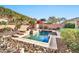 Beautiful backyard showcasing a custom pool and lush desert landscaping, creating a private retreat at 2462 W Turtle Hill Dr, Anthem, AZ 85086