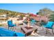 Backyard retreat with a sparkling pool, fire pit, and cozy seating, creating a perfect outdoor entertaining space at 2462 W Turtle Hill Dr, Anthem, AZ 85086