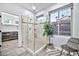 Modern glass-enclosed shower with tile surround, built-in shelving and neutral accents at 2462 W Turtle Hill Dr, Anthem, AZ 85086