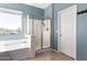 Inviting bathroom features a soaking tub, glass-enclosed shower, and ample natural light at 2489 E Sequoia Dr, Chandler, AZ 85286