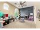 Large playroom with a ceiling fan, natural light, and plenty of space for activities at 2489 E Sequoia Dr, Chandler, AZ 85286