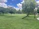 Well-manicured green community park with mature trees and a volleyball net at 2489 E Sequoia Dr, Chandler, AZ 85286
