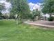 Inviting community walking path surrounded by green grass, trees, and well-maintained landscaping at 2489 E Sequoia Dr, Chandler, AZ 85286