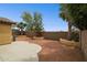 This home features desert landscaping, mature palm trees, stucco wall, and patio at 25087 W Dove Gap Dr, Buckeye, AZ 85326