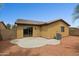 Cozy backyard featuring a stucco wall, desert landscaping, and a small patio at 25087 W Dove Gap Dr, Buckeye, AZ 85326