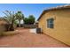 This home features a stucco wall, patio, mature palm trees, and desert landscaping at 25087 W Dove Gap Dr, Buckeye, AZ 85326
