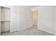 Bedroom with sliding-door closet and access to a hallway at 25087 W Dove Gap Dr, Buckeye, AZ 85326