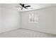 Bright bedroom with a ceiling fan, a window, and neutral carpet at 25087 W Dove Gap Dr, Buckeye, AZ 85326