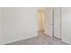 Bright bedroom featuring neutral gray carpet, freshly painted walls, and closet at 25087 W Dove Gap Dr, Buckeye, AZ 85326