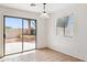Bright dining area with sliding glass door leading to the backyard patio and garden at 25087 W Dove Gap Dr, Buckeye, AZ 85326
