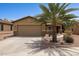 Charming single-story home features a two-car garage, desert landscaping, and a mature palm tree at 25087 W Dove Gap Dr, Buckeye, AZ 85326